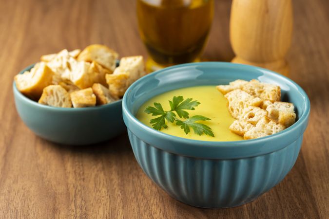 Bowl with onion soup and croutons on the table.