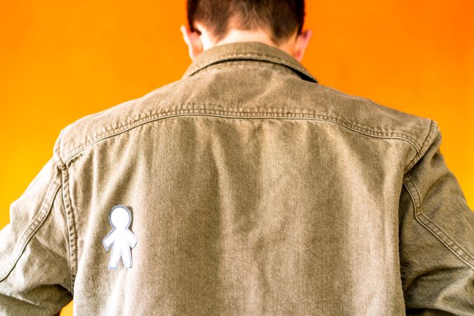 man with funny paper toy on jean jacket