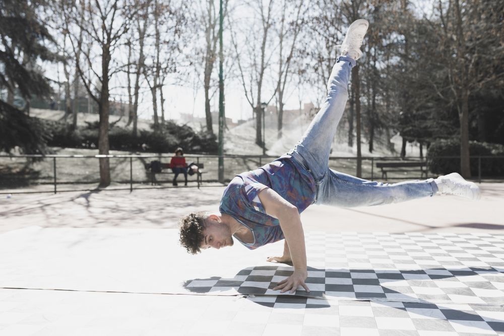 Man dancing break dance in park