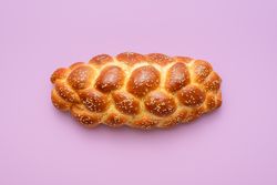 Challah bread above view, isolated on a purple background