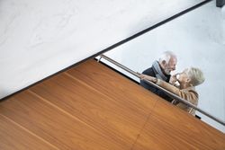 Older couple teasing each other and smiling on stairs