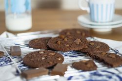 Warm chocolate cookies cooling off on rack
