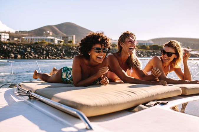 Beautiful young women relaxing on private yacht deck