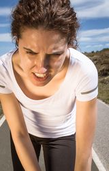 Close up of woman's face as she exercises outside