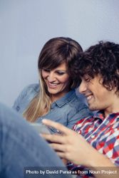 Cute couple in love looking smartphones and laughing 47mejB