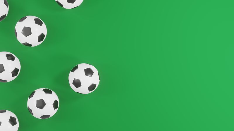 Soccer balls on green background