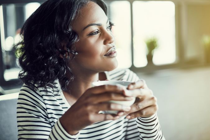 Thoughtful woman relaxing with a nice cup of coffee