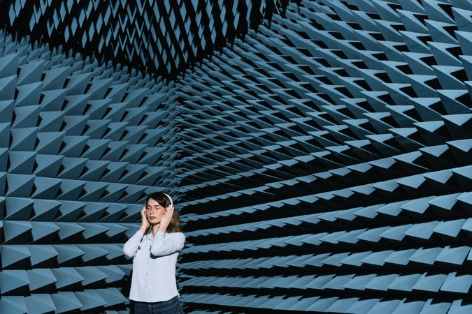 Woman in sound room listening to music