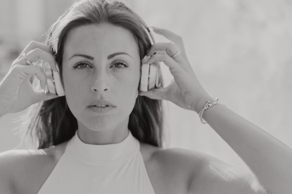 Brunette listening to music in sunlight
