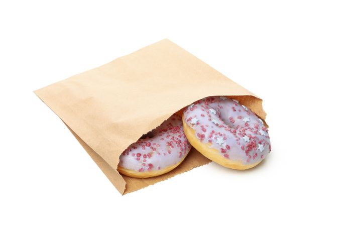 Paper bag with donuts isolated on plain background