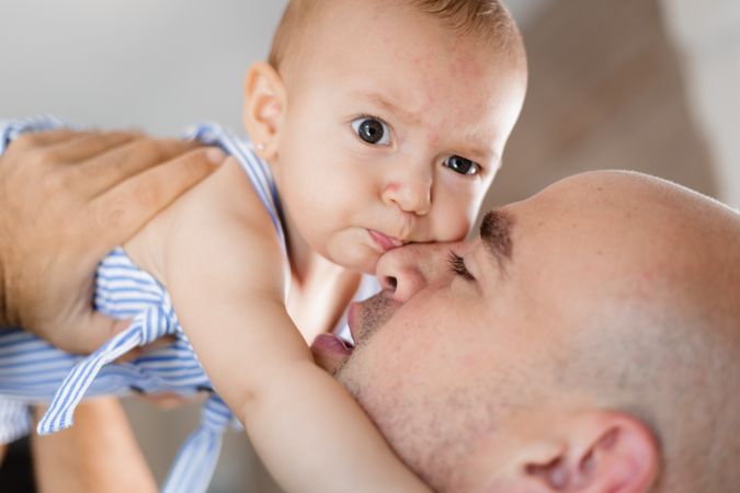 Father kissing baby on cheek