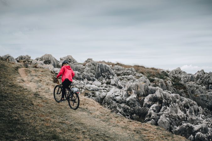 Female cyclist riding on mountain road