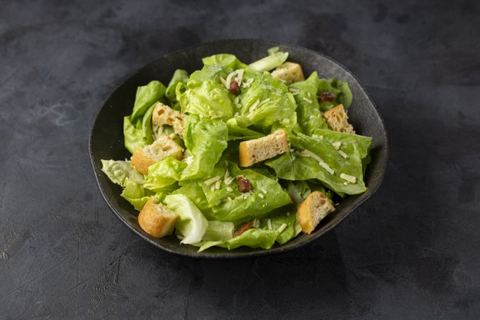 Caesar salad with croutons and bacon.