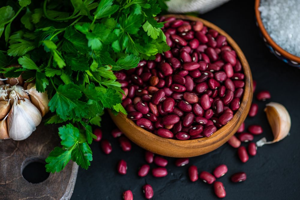 Close up bowl of dried kidney beans on kitchen counter 