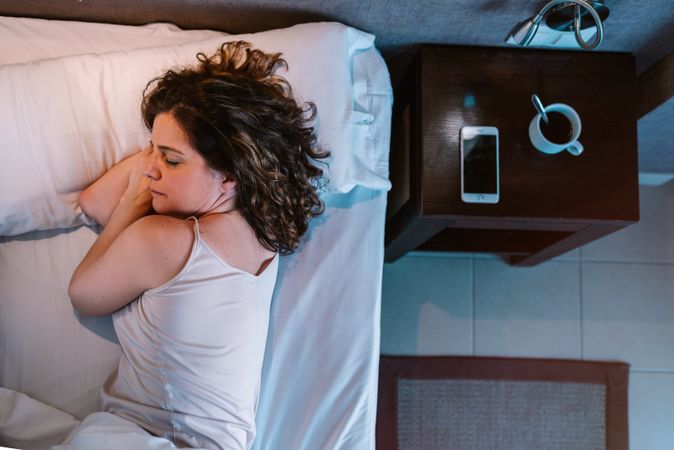 Woman dozing in bed after breakfast