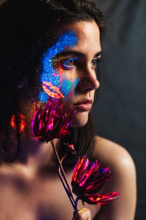 Young woman covered with uv painting