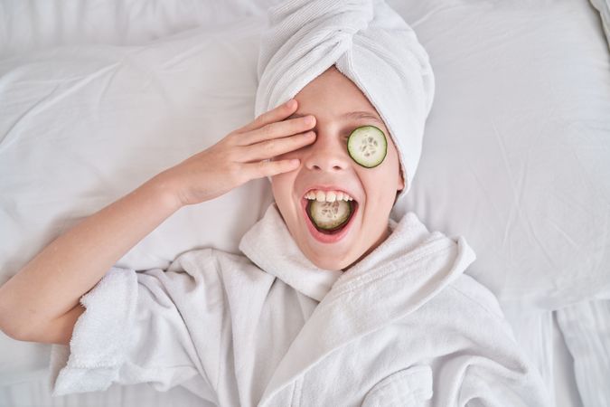Positive kid during spa procedures at home