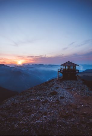 Silhouette of house on mountain during sunset