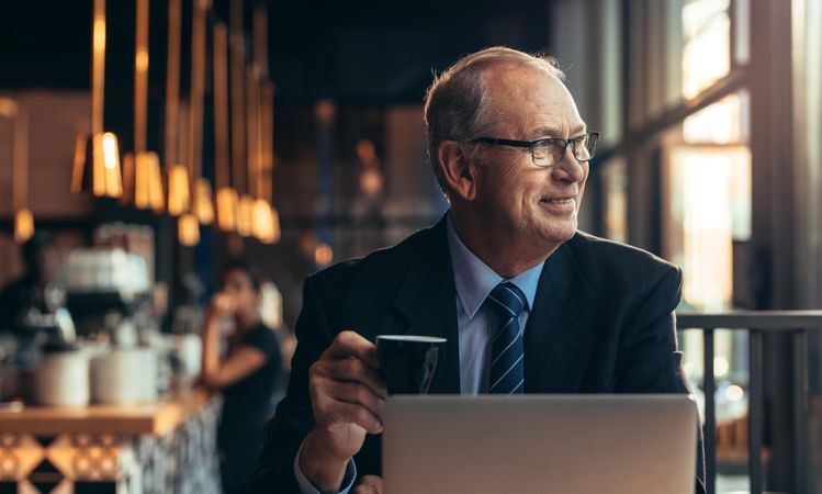 Content businessman enjoying coffee in cafe