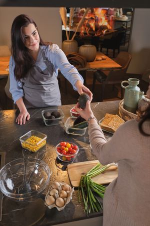 Positive women preparing lunch together