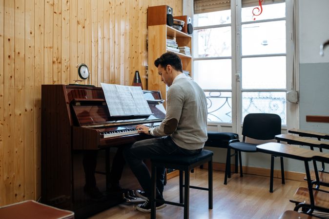 Man playing piano in studio