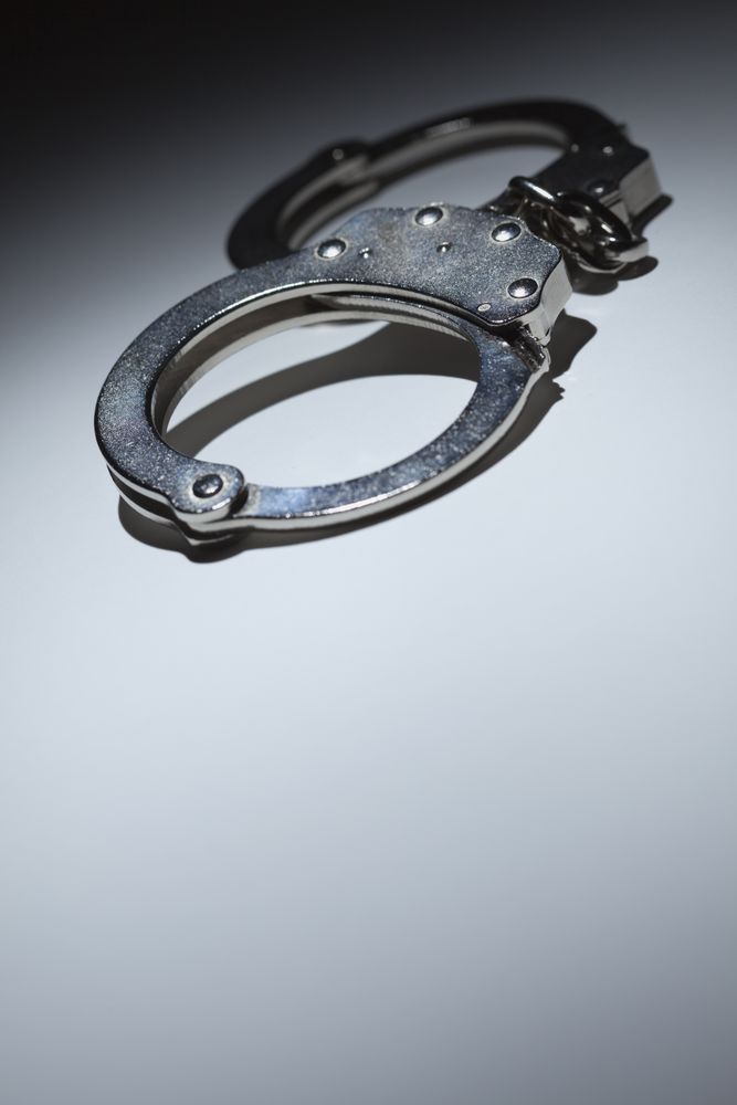 Abstract Pair of Handcuffs Under Spot Light - Text Room
