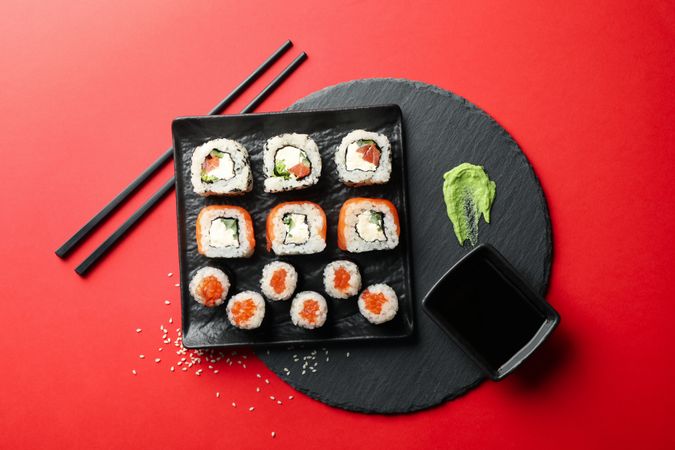 Delicious sushi rolls on red background. Japanese food