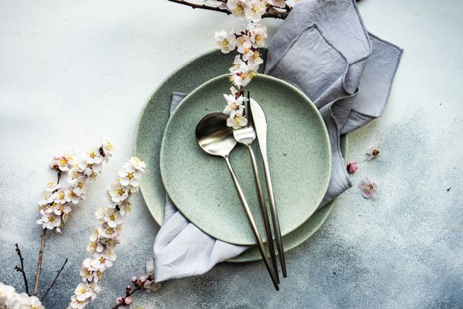 Minimalistic table setting with apricot blossom on elegant grey table setting