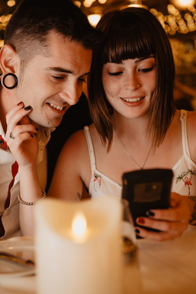 Couple using smartphone in luxury restaurant