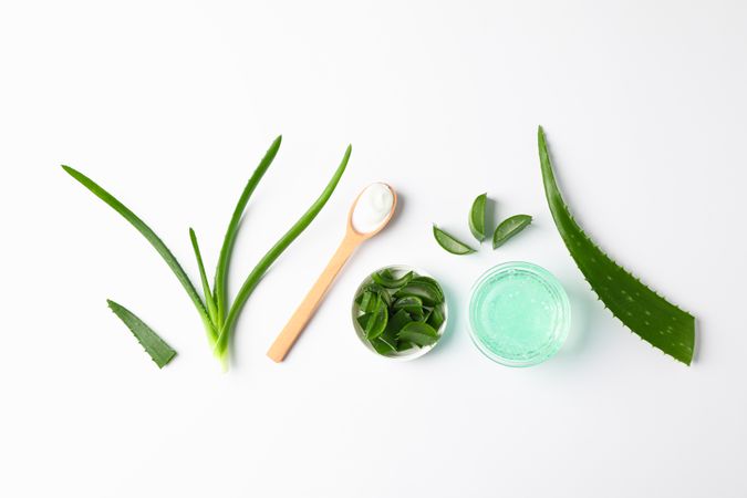 Flat lay composition with natural treatment accessories on plain background, space for text. Aloe vera