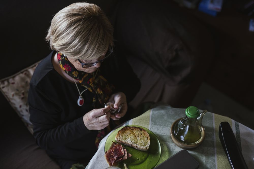 Mature woman eating tablet from pill box