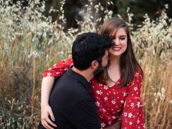 Young happy couple embracing in beautiful garden