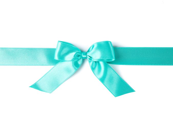 Turquoise ribbon with bow isolated on plain background. Gift concept