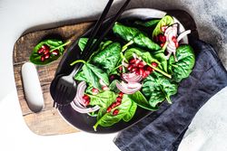 Fresh organic salad with spinach and pomegranate