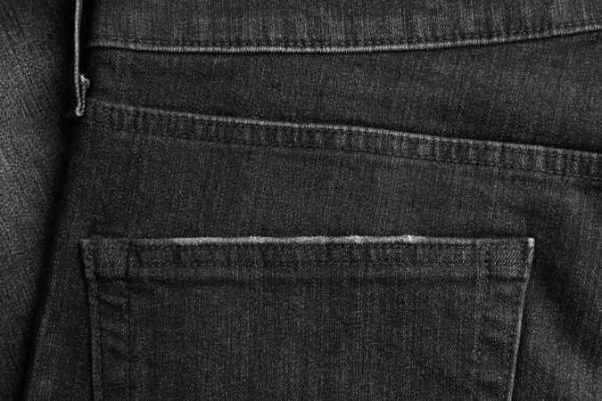 Closeup view of jeans pocket as background, space for text