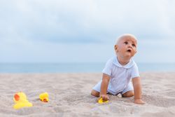 Baby boy playing with rubber ducks