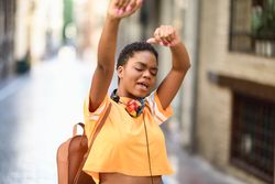 Female joyfully dancing in street