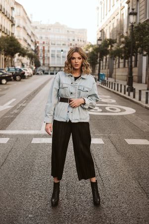 Stylish woman in middle of city road