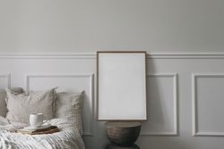 Bed with tray of coffee and blank picture frame