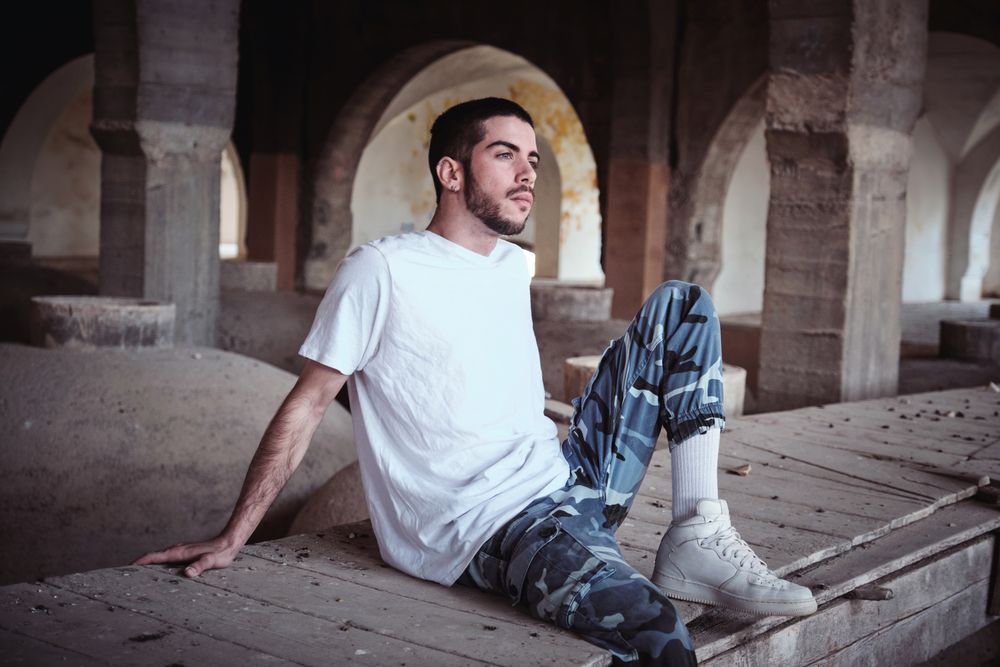 Dreamy cool man in neglected industrial building