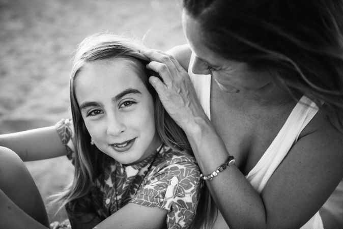 Woman with daughter on sunny beach