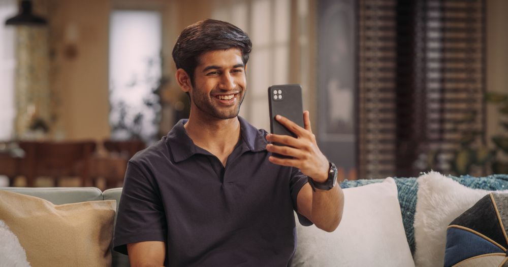 Indian Man on Video Call At Home: Balancing Remote Work Responsibilities, Joining Virtual Meetings and Presentations.