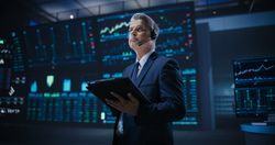 Professional Stock Exchange Trader Working on a Tablet Computer.