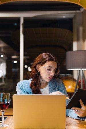 Young businesswoman using tablet in restaurant
