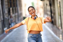 Female happily dancing in street