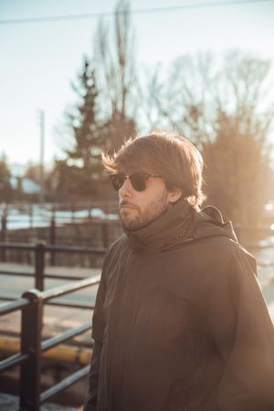 Men wearing sunglasses near hill in winter