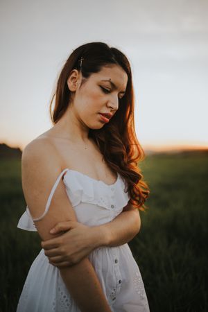 Barefoot woman with flowers in meadow
