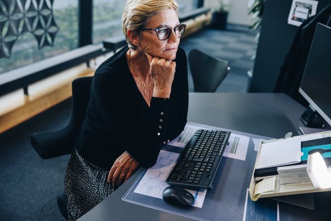 Professional woman reading something on her computer screen