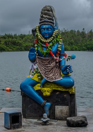 Blue Shiva statue on cloudy day