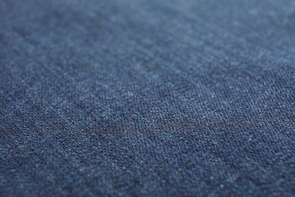 Texture of blue jeans as background, space for text
